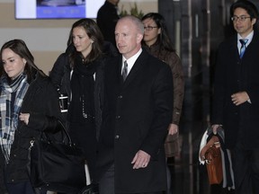 Deputy U.S. trade representative Jeffrey D. Gerrish, center, and his delegation leave the Westin hotel in Beijing, Monday, Jan. 7, 2019. The U.S. delegation led by Gerrish arrived in the Chinese capital for a trade talks with China. China sounded a positive note ahead of trade talks this week with Washington, but the two sides face potentially lengthy wrangling over technology and the future of their economic relationship.