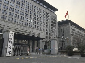 A Chinese paramilitary policeman stands guard at the main entrance gate of the Ministry of Commerce in Beijing, Wednesday, Jan. 9, 2019. U.S. and Chinese envoys extended trade talks into a third day Wednesday after President Donald Trump said negotiations aimed at ending a tariff war were "going very well!"