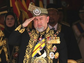 FILE - In this July 17, 2018, file photo, Malaysian King Sultan Muhammad V salutes during the national anthem at the opening of the 14th parliament session at the Parliament house in Kuala Lumpur, Malaysia. Malaysia King Sultan Muhammad V has abdicated in an unexpected and rare move, just after two years on the throne. The palace said in a statement on Sunday, Jan. 6, 2019, that Sultan Muhammad V, 49, has resigned with immediate effect, cutting short his five-year term, without giving any reasons. Sultan Muhammad V, ruler of northeast Kelantan state, was installed in December 2016 as one of the country's youngest constitutional monarchs.