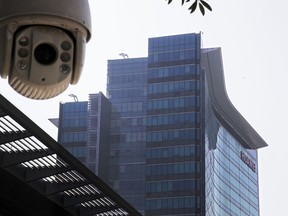 In this Dec. 18, 2018, photo, a surveillance camera is mounted near the Huawei headquarters in Shenzhen in south China's Guangdong province. The U.S. Justice Department unsealed criminal charges Monday, Jan. 28, 2019 against Chinese tech giant Huawei, a top company executive and several subsidiaries, alleging the company stole trade secrets, misled banks about its business and violated U.S. sanctions.