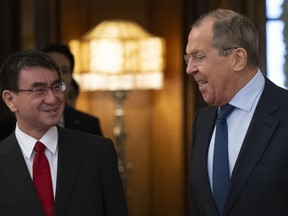 Russian Foreign Minister Sergey Lavrov, right, and Japanese Foreign Minister Taro Kono enter a hall for their talks in Moscow, Russia, Monday, Jan. 14, 2019.