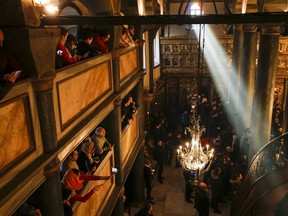 Visitors wait for a religion service at the Patriarchal Church of St. George in Istanbul, Sunday, Jan. 6, 2019. An independent Ukrainian Orthodox church has been created at a signing ceremony in Turkey, formalizing a split with the Russian church it had been tied to since 1686.
