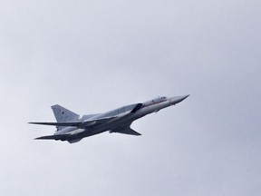 FILE - In this Thursday, May 5, 2016 file photo, a Russian Tu-22 bomber flies over Moscow's Kremlin during a general rehearsal for the Victory Day military parade which will take place at Moscow's Red Square on May 9 to celebrate 71 years after the victory in WWII in Moscow, Russia. The Russian military says that one of its long-range bombers has crash-landed in the Arctic, Tuesday Jan. 22, 2019, killing two of its crew of four.