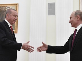 Russian President Vladimir Putin, right, greets Turkey's President Recep Tayyip Erdogan prior to their talks in the Kremlin in Moscow, Russia, Wednesday, Jan. 23, 2019.