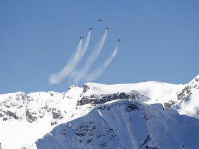 The Patrouille Suisse, an aerobatic team of the Swiss Air Force, flies ahead of an alpine ski, men's World Cup downhill, in Wengen, Switzerland, Saturday, Jan. 19, 2019.