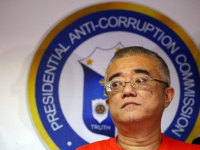 Xie Haojie, who was arrested in Manila in an operation coordinated with Chinese authorities, is presented to the media at a news conference in Manila, Philippines Wednesday, Jan. 16, 2019. Philippine officials have turned over to China the former government official wanted for alleged economic crime and corruption.