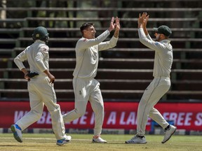 South Africa's bowler Duanne Olivier, center, celebrates dismissing Pakistan's batsman Sarfraz Ahmed on day four of the third cricket test match between South Africa and Pakistan at Wanderers Stadium in Johannesburg, South Africa, Monday, Jan.14, 2019.