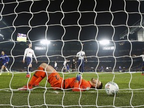 Tottenham Hotspur goalkeeper Paulo Gazzaniga, front, reacts after Chelsea's Eden Hazard scores his side's second goal during the second leg of the English League Cup semifinal soccer match between Chelsea and Tottenham Hotspur at Stamford Bridge stadium in London, Thursday, Jan. 24, 2019.