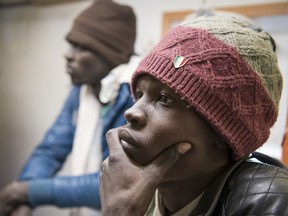Some of the 17 people rescued in the Mediterranean Sea sit aboard the German rescue ship Sea-Eye afloat off Malta, Tuesday, Jan. 8, 2019. Two German nonprofit groups appealed to European Union countries Tuesday to take in 49 migrants who are stuck on rescue ships in the Mediterranean Sea, warning of the passengers' deteriorating health.