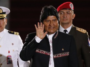 Bolivia's President Evo Morales waves as he arrives to the Supreme Court for the inauguration ceremony of President Nicolas Maduro in Caracas, Venezuela, Thursday, Jan. 10, 2019. Maduro will be sworn in to a second term amid international calls for him to step down and a devastating economic crisis, but with some long-time friends in attendance both from abroad and at home.