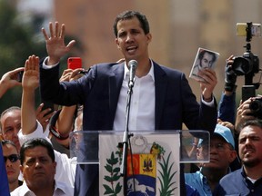 Juan Guaido, head of Venezuela's opposition-run congress, declares himself interim president of Venezuela, during a rally demanding President Nicolas Maduro's resignation in Caracas, Venezuela, Wednesday, Jan. 23, 2019.