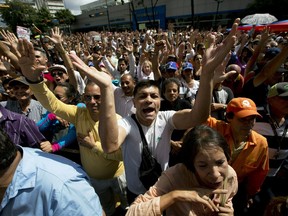 Opposition members shout "Guaido President" during public a session of National Assembly at a street in Caracas, Venezuela, Friday, Jan. 11, 2019. Juan Guaido, the head of Venezuela's opposition-run congress says that with the nation's backing he's ready to take on Nicolas Maduro's presidential powers and call new elections.