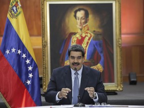 Venezuela's President Nicolas Maduro holds a press conference with foreign media at Miraflores presidential palace where an image of Venezuelan independence hero Simon Bolivar is displayed in Caracas, Venezuela, Wednesday, Jan. 9, 2019. Maduro will be sworn-in for a second, six-year term on Thursday.