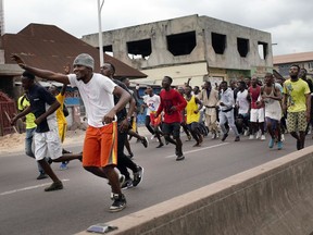 Congolese sportsmen run towards the main stadium in Kinshasa, Congo, Tuesday Jan. 8, 2019, to participate in a general boxing and martial arts competition. As Congo anxiously awaits the outcome of the presidential election, many in the capital say they are convinced that the opposition won and that the delay in announcing results is allowing manipulation in favor of the ruling party.