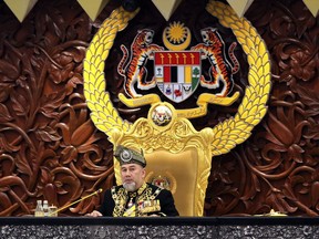 FILE - In this July 17, 2018, file photo, Malaysian King Sultan Muhammad V delivers the opening speech at the 14th parliament session at the Parliament House in Kuala Lumpur, Malaysia. Sultan Muhammad V shocked the nation by announcing his abdication in January 2019, days after returning from two months of medical leave. The 49-year-old sultan from eastern Kelantan state only reigned for two years as Malaysia's 15th king and didn't give any reason for quitting.