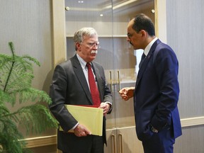 U.S. National Security Adviser John Bolton, left, and his Turkish counterpart and senior adviser to President Recep Tayyip Erdogan, Ibrahim Kalin, right, meet at the Presidential Palace in Ankara, Turkey, Tuesday, Jan. 8, 2019.  Bolton has said he is trying to negotiate the safety of Kurdish allies in northeastern Syria in the fight against the Islamic State group. (Presidential Press Service via AP, Pool)