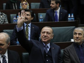 Turkey's President Recep Tayyip Erdogan waves as he arrives to deliver a speech to MPs of his ruling Justice and Development Party (AKP) at the parliament in Ankara, Turkey, Tuesday, Jan. 8, 2019.