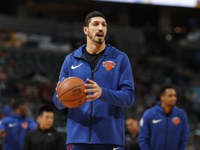 FILE - In this Jan. 1, 2019, file photo, New York Knicks center Enes Kanter, of Turkey, warms up prior to the team's NBA basketball game against the Denver Nuggets, in Denver. Turkish media reports said Wednesday, Jan. 16, 2019, that Turkish prosecutors are seeking an international arrest warrant and had prepared an extradition request for Kanter, accusing him of membership in a terror organisation. Sabah newspaper said prosecutors were seeking an Interpol "Red Notice" citing Kanter's ties to Fethullah Gulen, who Turkey blames for a failed 2016 coup, and accusing him of providing financial support to the group.