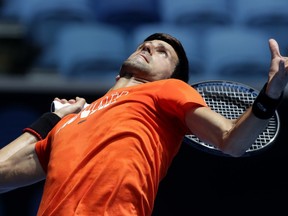 Serbia's Novak Djokovic serves to Britain's Andy Murray during a practice match on Margaret Court Arena ahead of the Australian Open tennis championships in Melbourne, Australia, Thursday, Jan. 10, 2019.