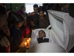 Family members pay their final respects to Felipe Gomez Alonzo, an 8-year-old Guatemalan boy who died in U.S. custody, in Yalambojoch, Guatemala, Saturday, Jan. 26, 2019. Felipe came from a rural community with extreme poverty. He was taken to the border by his father and detained by the U.S. Border Patrol before he fell ill on December 2018 and died.