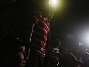 Honduran migrants wait to enter Guatemala, at the border crossing in Agua Caliente, Guatemala, Tuesday, Jan. 15, 2019. The latest caravan of Honduran migrants hoping to reach the U.S. has crossed into Guatemala, under the watchful eyes of about 200 Guatemalan police and soldiers.