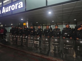 Anti-riot police stand guard at the La Aurora International Airport in Guatemala City, Sunday, Jan. 6, 2019. The Guatemalan government banned the entry of Yilen Osorio, an official of the International Commission Against Impunity in Guatemala (CICIG) and keeps it in the facilities of the La Aurora International Airport, despite the fact that the Constitutional Court ordered that they be granted visas and access to the members of the organism.