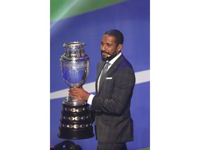 Chile Soccer player Jean Beausejour holds the trophy during the draw for the 2019 Copa America soccer tournament in Rio de Janeiro, Brazil, Thursday, Jan. 24, 2019. Brazil will host the continental soccer tournament in June and July.