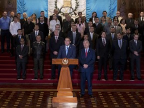 Guatemala's President Jimmy Morales, center, gives a statement, at the National Palace in Guatemala City, Monday, Jan. 7, 2019. Guatemala announced that it is going to withdraw from UN-sponsored anti-corruption commission.