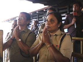 In this Monday, Nov. 5, 2018, photo, Indian policewomen, above the age of 50, offer prayers at Sabarimala temple, one of the world's largest Hindu pilgrimage sites, in the southern Indian state of Kerala, India. Reports of two women of menstruating age, or between the age of 10 to 50, entering the temple on Wednesday, Jan. 2, have lead to protests across the state. India's Supreme Court on Sept. 28, 2018 lifted the ban on women of menstruating age from entering the temple, holding that equality is supreme irrespective of age and gender.
