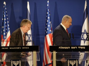 Israeli Prime Minister Benjamin Netanyahu, right, and US National Security Advisor John Bolton, leave the stage after their statement to the media follow their meeting, in Jerusalem, Sunday, Jan. 6, 2019.