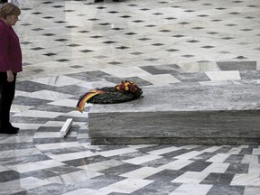 German Chancellor Angela Merkel places a wreath at the monument of the Unknown Soldier during her visit in Athens, Friday, Jan. 11, 2019. Merkel is widely blamed in Greece for the austerity that the country has lived through for much of the past decade, which led to a sharp and prolonged recession and a consequent fall in living standards.