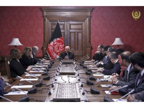 In this photo released by the Afghan Presidential Palace, Afghan President Ashraf Ghani, center, speaks to U.S. peace envoy Zalmay Khalilzad, third left, at the presidential palace in Kabul. Afghanistan, Monday, Jan. 28, 2019. The Afghan president's office said Monday that Khalilzad shared details of his recent talks with the Taliban in Qatar with Ghani and other Afghan government officials. A statement from the office quotes Khalilzad as saying he held talks about a cease-fire with the Taliban but that there has been no progress yet on that issue. (Afghan Presidential Palace via AP)