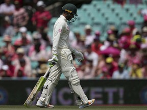 Australia's Usman Khawaja walks off after he was caught out for 27 runs on day 3 of their cricket test match against India in Sydney, Saturday, Jan. 5, 2019.