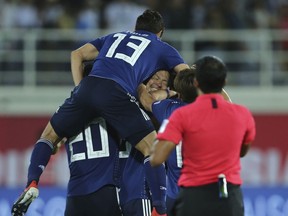 Japan players celebrate after Japan's Tsukasa Shiotani, centre, scored his side's second goal during the AFC Asian Cup group F soccer match between Japan and Uzbekistan at Khalifa bin Zayed Stadium in Al Ain, United Arab Emirates, Thursday, Jan. 17, 2019.