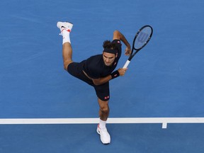 Switzerland's Roger Federer plays a shot during his match against at Frances Tiafoe of the United States at the Hopman Cup in Perth, Australia, Tuesday, Jan. 1, 2019.