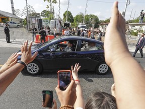 People wave as Pope Francis rides past in Panama City, Thursday, Jan. 24, 2019. Francis opens his first full day Thursday with a visit to the presidential palace and rounds out the day with his evening welcome to tens of thousands of young Catholics gathered for World Youth Day, the church's big youth rally.