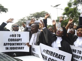 Zimbabwe lawyers take part in a protest over rule of law concerns in Harare, Tuesday Jan. 29, 2018. The lawyers handed over a petition to the country's Chief Justice in a bid to stop human rights abuses in the country. Zimbabwe's president Monday said he was "appalled" by a televised report showing abuses by security forces in a continuing crackdown after angry protests against the government's drastic fuel price hikes.