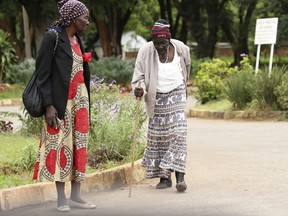 In this Jan. 9, 2019, photo, an elderly woman slowly makes her way to Parirenyatwa Hospital in Harare, Zimbabwe, with the hope of being treated and receiving medication. A doctors strike in Zimbabwe has crippled a health system that was already in intensive care from neglect. It mirrors the state of affairs in a country that was full of promise a year ago with the departure of longtime leader Robert Mugabe but now faces economic collapse.