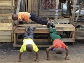 Children use a deserted market stall into an exercise bench as business came to a standstill on the third day of protests over the hike in fuel prices in Harare, Zimbabwe, Wednesday, Jan. 16, 2019. Streets are deserted in Harare on Wednesday as a general strike continues for a third day to protest the government's decision to more than double the price of fuel.