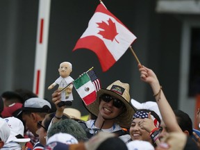Pilgrims hold Canada, Mexico and U.S. flags as Pope Francis rides the pope mobile through the streets of Panama City, Panama, Wednesday, Jan, 23, 2019. Pope Francis is in Panama to attend World Youth Day, the church's once-every-three-year pep rally that aims to invigorate the next generation of Catholics in their faith.