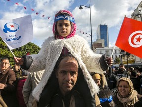 Followers of moderate islamist party Ennahdha march to celebrate the eighth anniversary of the democratic uprising in Tunis, Monday, Jan.14, 2019. Tunisia is marking eight years since its democratic uprising amid deepening economic troubles and simmering anger at the revolution's unfulfilled promises.