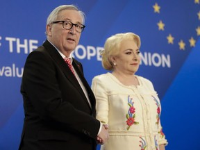 European Union's Commission President Jean-Claude Junker, left, shakes hands with Romanian Premier Viorica Dancila at the Victoria palace in Bucharest, Romania, Friday, Jan. 11, 2019 during a visit marking the official start of the Romanian Presidency of the Council of the European Union.