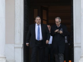 Greek Defense Minister Panos Kammenos, left, leaves Maximos mansion following a meeting with Greece's Prime Minister Alexis Tsipras, in Athens, Sunday, Jan. 13, 2019. Greek defense Minister Kammenos, leader of the right-wing populist Independent Greeks party, is vehemently opposed to a deal with neighboring Macedonia over its state name.