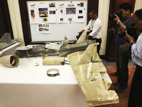 FILE - In this June 19, 2018 file photo, photographers take pictures of what U.A.E. officials described as an Iranian Qasef drone captured on the battlefield in Yemen during a news conference in Abu Dhabi, United Arab Emirates. A deadly bomb-laden drone flown by Yemen's Houthi rebels flew into a military parade on Thursday, Jan. 10, 2019, outside of the southern port city of Aden, targeting high-ranking military officials in Yemen's internationally recognized government. The brazen attack threatens U.N.-brokered peace efforts to end the yearslong war tearing at the Arab world's poorest nation.