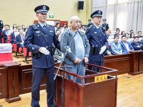 This photo taken on March 30, 2018 shows Gao Chengyong (C) in the Baiyin Intermediate People's Court in Baiyin in China's northwestern Gansu province.