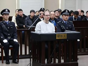 This photograph taken and released by the Intermediate Peoples' Court of Dalian on January 14, 2019 shows Canadian Robert Lloyd Schellenberg (C) during his retrial on drug trafficking charges in the court in Dalian in China's northeast Liaoning province.