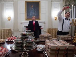 Trump lorded over the repast: there were crinkly, grease-stained papers of McDonald's and Wendy's as far as the eye could see, lit up by the spectacular gold candleabras.