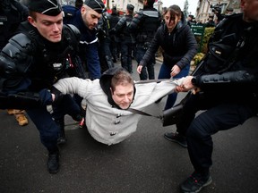 A man is arrested by gendarmes as he was protesting against French President's visit for a meeting gathering some 600 mayors who will relay the concerns aired by residents in their towns and villages in the Normandy city of Grand Bourgtheroulde on January 15, 2019, as part of the official launch of the "great national debate," a central plank of French President's bid to turn around his embattled presidency.