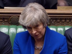 A video grab from footage broadcast by the UK Parliament's Parliamentary Recording Unit (PRU) shows Britain's Prime Minister Theresa May reacting as opposition Labour Party Leader Jeremy Corbyn makes a point of order after the result of the vote on the no confidence motion, in the House of Commons in central London on January 16, 2019. - British Prime Minister Theresa May on Wednesday survived a no-confidence vote sparked by the crushing defeat of her Brexit deal just weeks before the UK leaves the European Union.