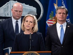 Secretary of Homeland Security Kirstjen Nielson speaks alongside Acting US Attorney General Matthew Whitaker (L) and FBI Director Christopher Wray as they announce a 13-count indictment of financial fraud charges against Chinese telecommunications manufacturer Huawei, as well as two affiliated companies and Huawei's Chief Financial Officer Wanzhou Meng, during a press conference at the Department of Justice in Washington, DC, January 28, 2019.